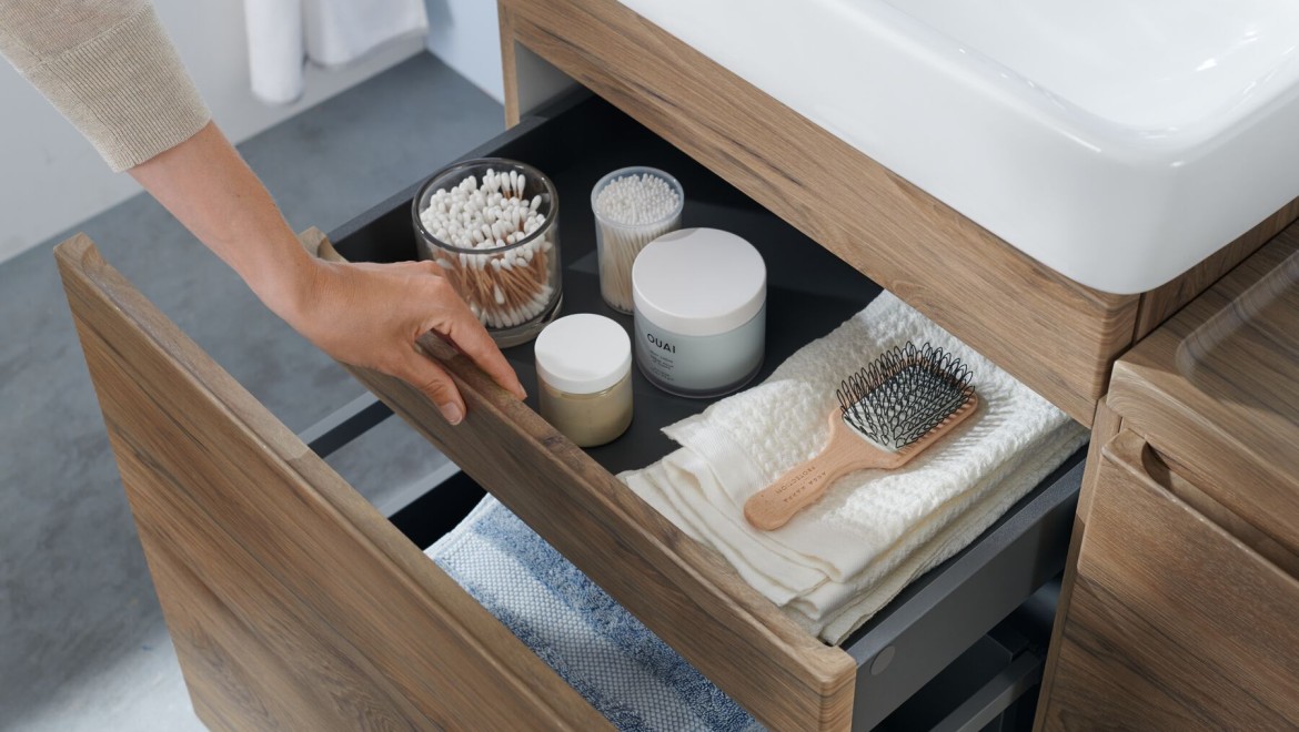 Woman opens Geberit Renova Plan vanity unit